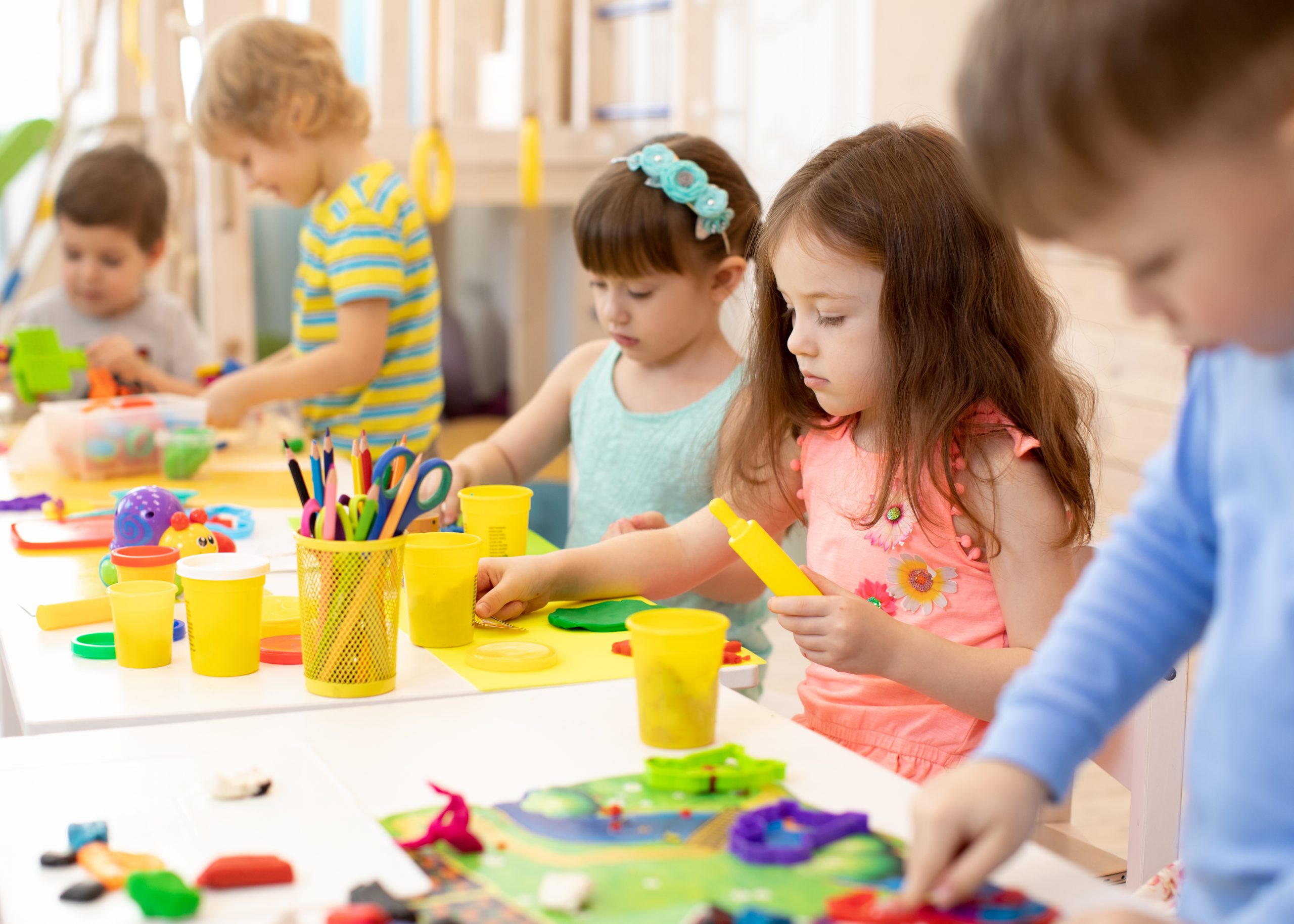 Art and craft activity in kindergarten. Group of preschool kids hands working in daycare center. Art and craft activity in kindergarten. Preschool kids hands working in day care center. Group of children engaged in handcrafts